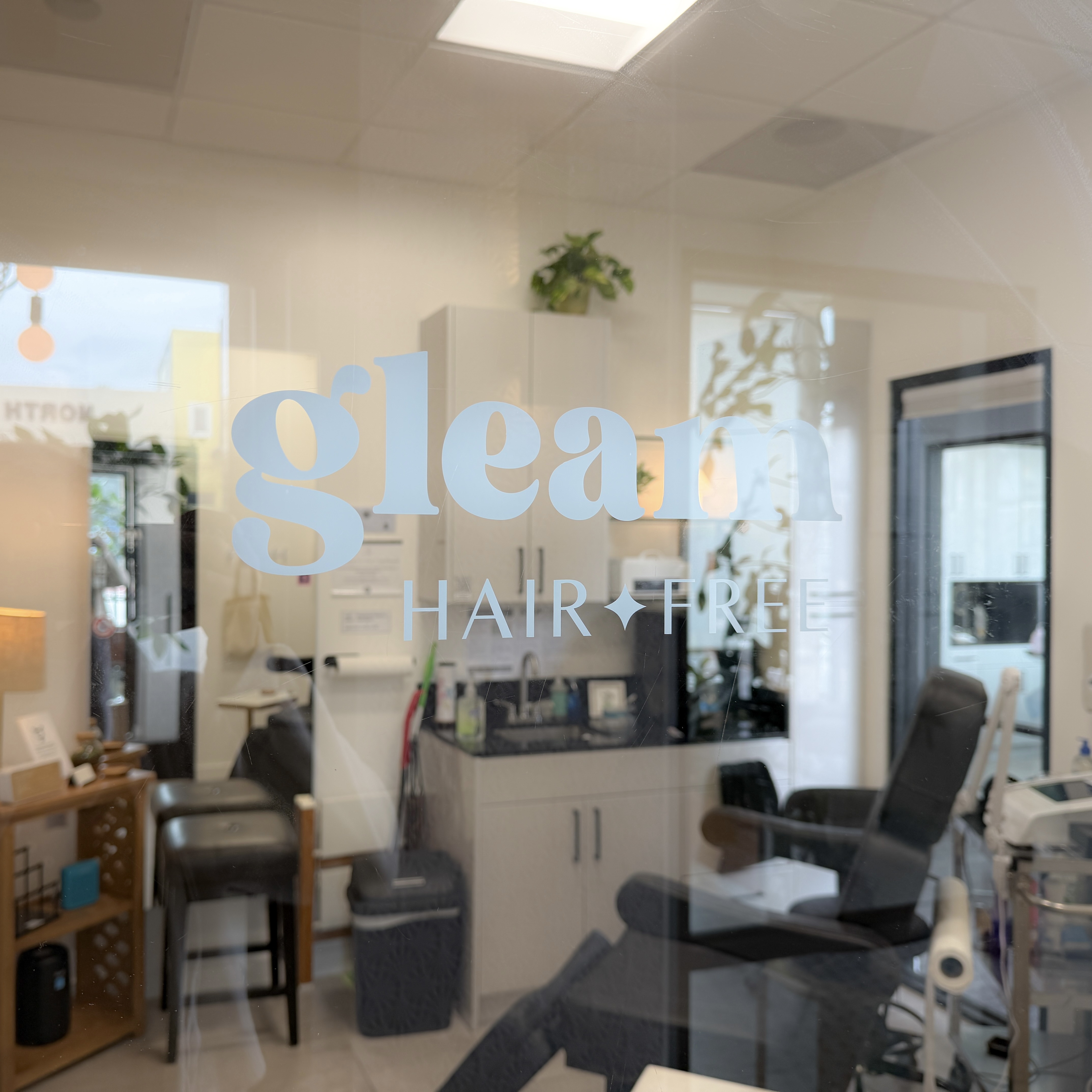 Gleam Hair Free logo on studio window